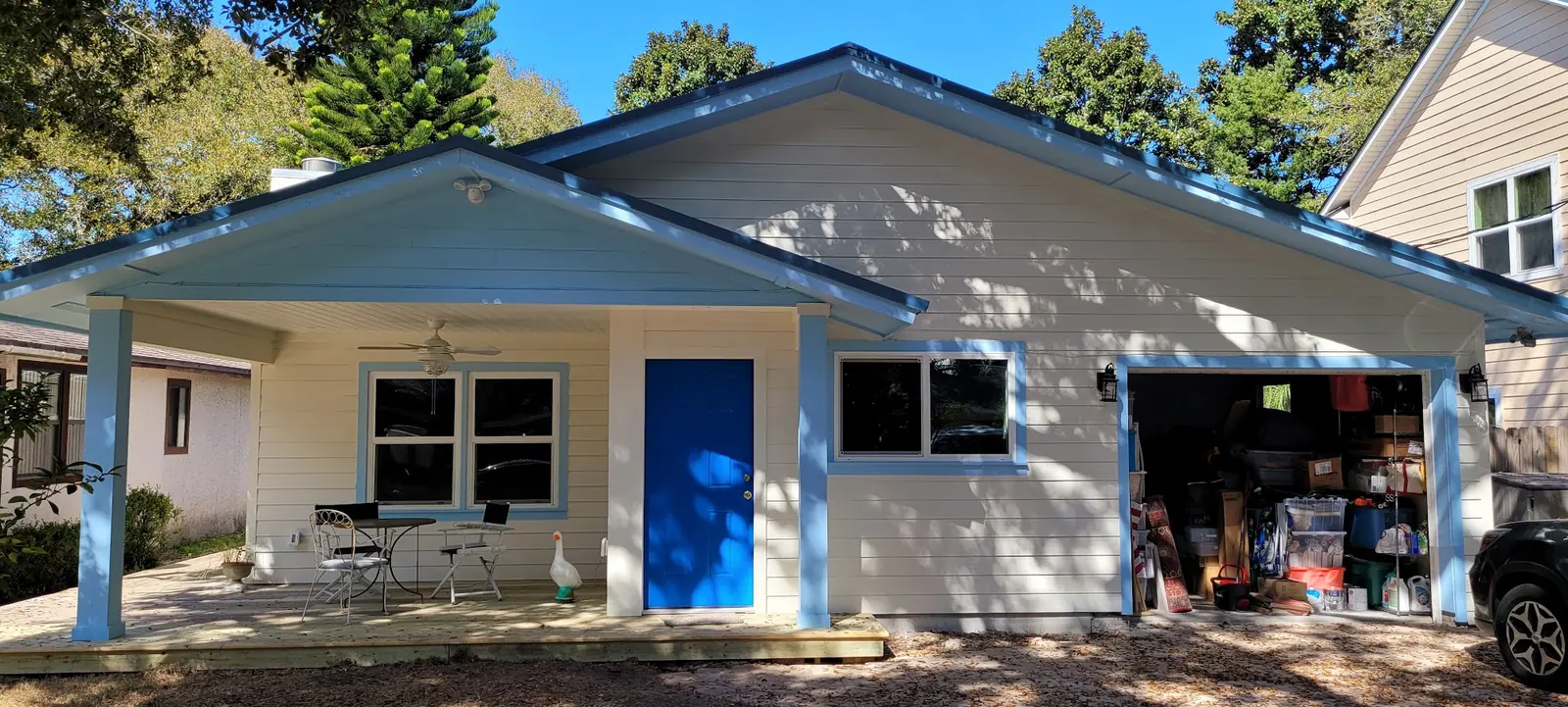 House with blue trim and an open garage